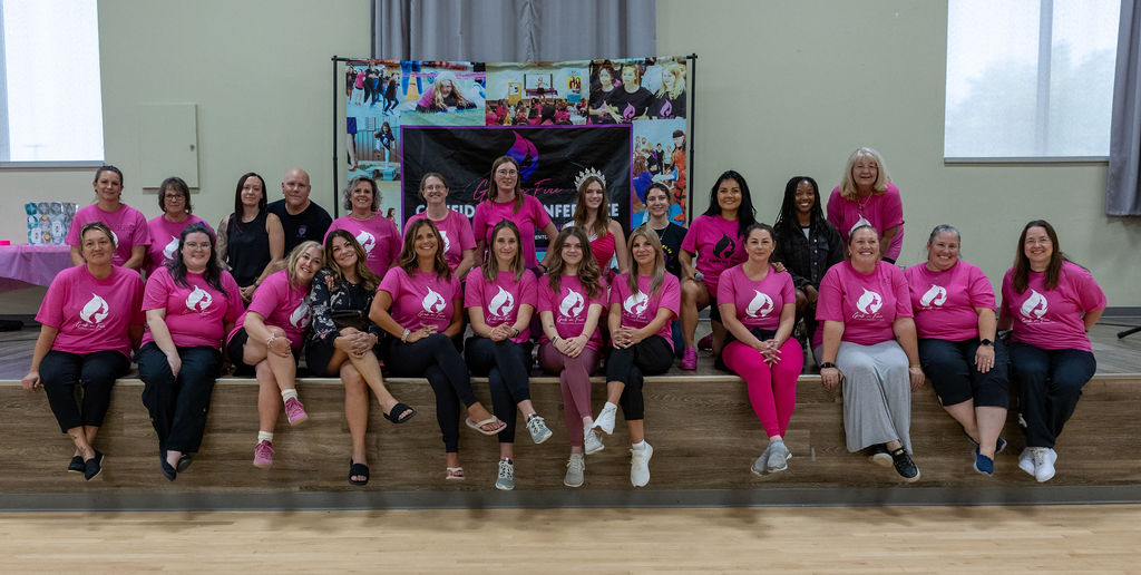 Girls On Fire leadership mentors and volunteers in Alberta sitting together during a girls-only empowerment and leadership program.