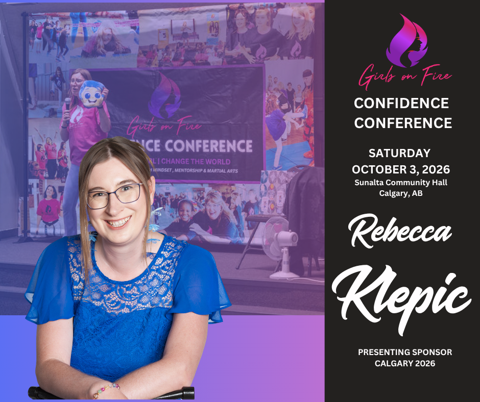 A smiling woman with glasses and long brown hair sits in front of a conference banner in Calgary. Text reads: Girl on Fire Confidence Conference, October 3, 2026, Calgary, AB. Rebecca Klepic. Presenting Sponsor Calgary 2026.